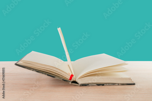 Open Book Old On Wooden Floor Isolated On Blue Background With