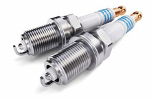 Two Spark Plugs On A White Background