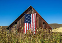 Weathered Red Barn With American Flag