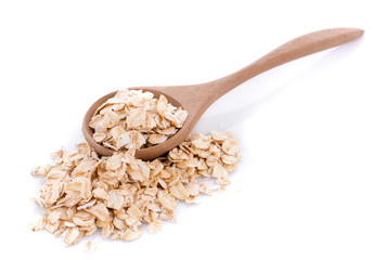 Wall Mural - Oat flakes pile in wooden spoon on white background