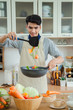 © nikomsolftwaer - Asian young man is cooking