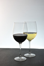 Two Glasses Of Wine Red  In Front Of White