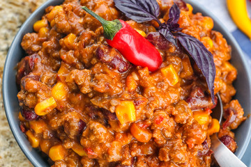 Wall Mural - Bowl with chili con carne on table, closeup