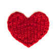 Red heart knitted from threads on a white background