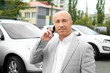 © Africa Studio - Bald man in jacket talking on phone outdoors
