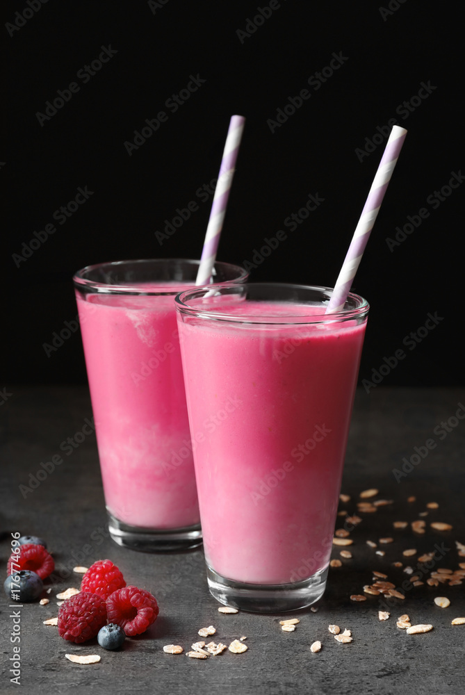 Glasses with berry protein shakes on table