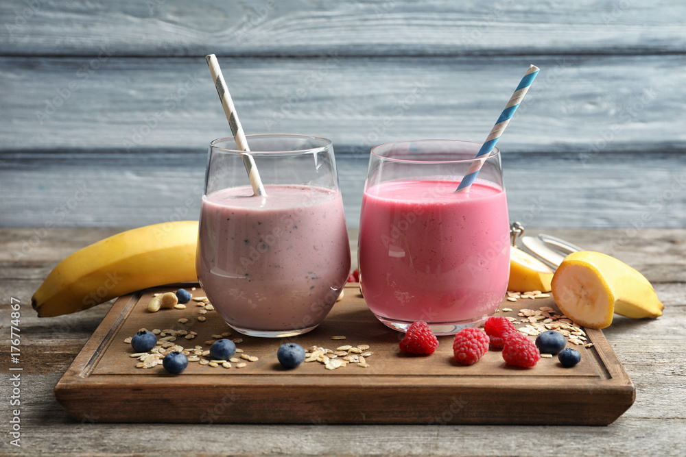 Glasses with berry protein shakes on table