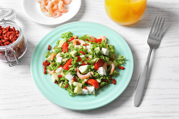 Wall Mural - Plate with delicious goji berry salad on table
