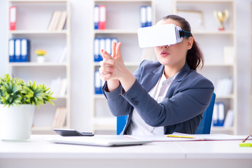 Businesswoman with virtual reality glasses in office