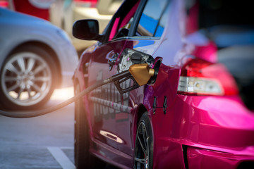  filling gasoline in car with a nozzle. 