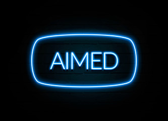 Aimed  - colorful Neon Sign on brickwall