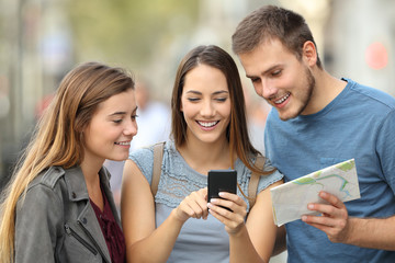 Three tourists checking location on the street