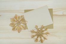 Top View Of  Blank Christmas Card With Handmade Snowflakes On A Wooden Background. Christmas Background In Natural Tones.