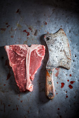 Fresh red steak on old metal table