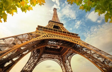eiffel tower in paris france with golden light rays.