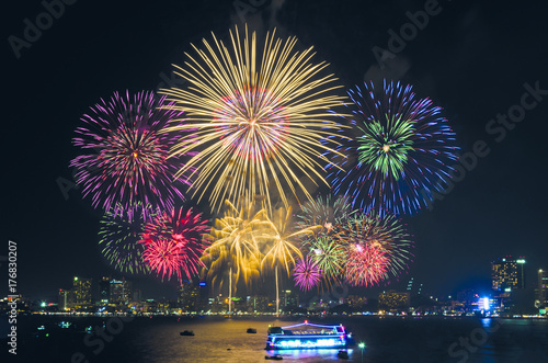 Fireworks Over Cityscape By The Beach And Sea Surrounding