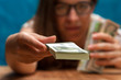© pavel_shishkin - Young woman wearing eyeglasses with money in hands