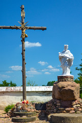 Cross and sculpture at the church in Nesvizh, Belarus