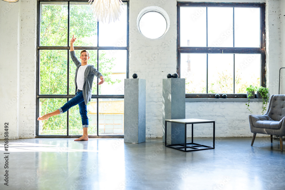 A Handsome Young Male Ballet Dancer Practicing In A Loft