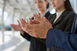 © shutterdemon - business people clap their hands to congratulate the signing of an agreement or contract between their firms, companies, enterprises. success, dealing, greeting and partner concept.