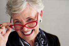 Portrait Of Smiling Senior Woman Wearing Red Eyeglasses