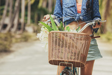 Woman Carrying Flowers In The Bike Basket