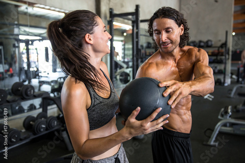 Cuadros en Lienzo Collaborative group medicine ball exercise fitness routine between coed male and