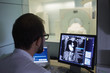 © Miquel Llonch/Stocksy - Image diagnosis technician cheking the computerized image  from the scann in the screen