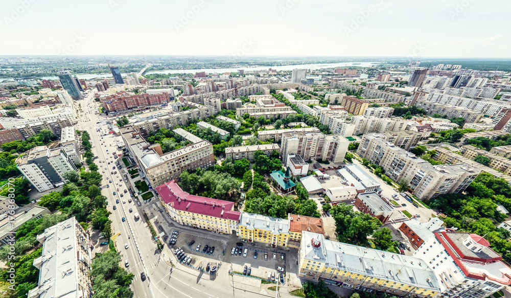 Aerial city view with crossroads and roads, houses, buildings, parks and parking lots, bridges. Helicopter drone shot. Wide Panoramic image. - obrazy, fototapety, plakaty 