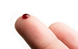 Drop of blood on finger on white background