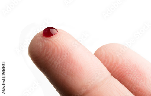Fotografía Drop of blood on finger on white background