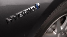 Focus Is Made On The Hybrid Badge Of A Car.