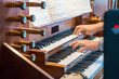 © johnkruger1 - Close up view of a organist playing a pipe organ