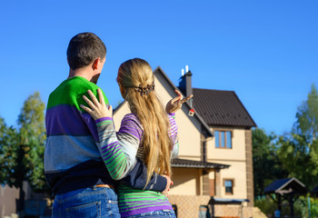 Wall Mural - Young Couple Standing Outside Dream Home