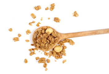 Wall Mural - Crunchy granola, muesli pile in metal spoon with nuts isolated on white background, top view