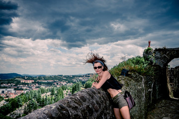 Wall Mural - Femme en haut du rocher Saint-Michel d'Aiguilhe  au Puy-en-Velay pendant un orage