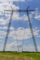 High power tower pole against blue sky in Romania. Silhouette of international electrical power line view . Electrical power lines and pylons.