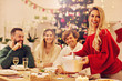 © Kalim - Group of family and friends celebrating Christmas dinner