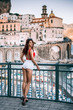 Fashion portrait of a young beautiful girl in red bikini and white shorts in Atrani, Amalfi coast, Italy, Europe