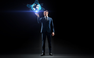 Poster - businessman with earth hologram over black