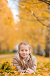 © travnikovstudio - Portrait of adorable little girl with yellow leaves bouquet in fall