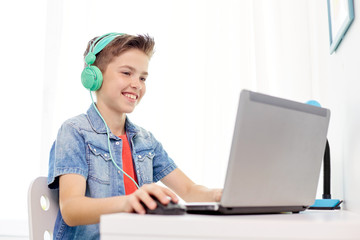 Poster - boy in headphones playing video game on laptop