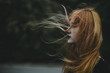 © Jovana Rikalo/Stocksy - Young woman with hair blowing in the wind