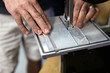 © Carolyn Lagattuta/Stocksy - Man cutting a piece of plastic with a band saw