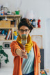 © Julien L. Balmer/Stocksy - Young Female Artist Holding Paint Brush