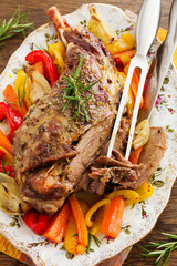 Canvas Print - Roast leg of lamb with rosemary and garlic and vegetables.