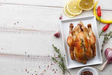 Wall Mural - Roasted chicken with herbs and spices for Christmas or Thanksgiving holiday dinner, top view