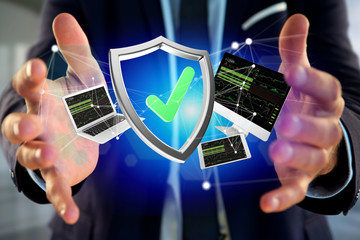 Wall Mural - shield symbol surrounded by devices and network displayed on a futuristic interface