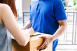 © Art_Photo - Woman putting signature in clipboard on cardboard box with delivery man
