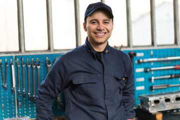 Canvas Print - Smiling mechanic in front of his tools